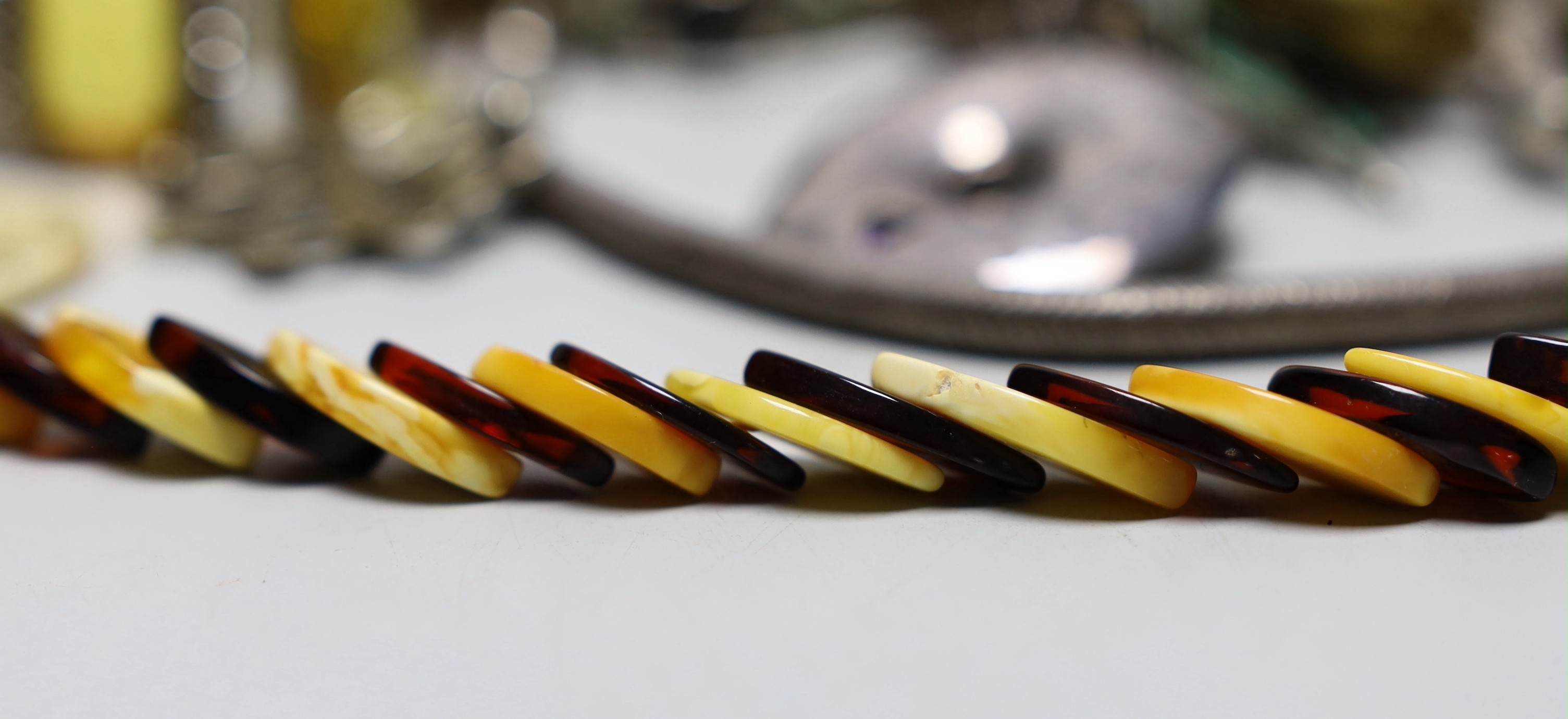 Sundry jewellery including silver and gem set circular brooch, costume and other items.